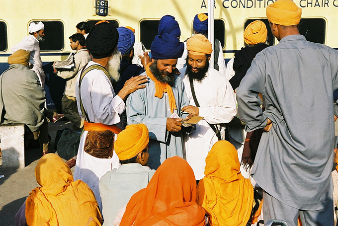 A group of Indian Sikhs congregate at the town's main train station.