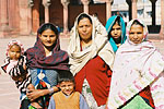 A family poses for a foreign tourist in the grounds of the 17th-century Jama Masjid, one of India's largest mosques.