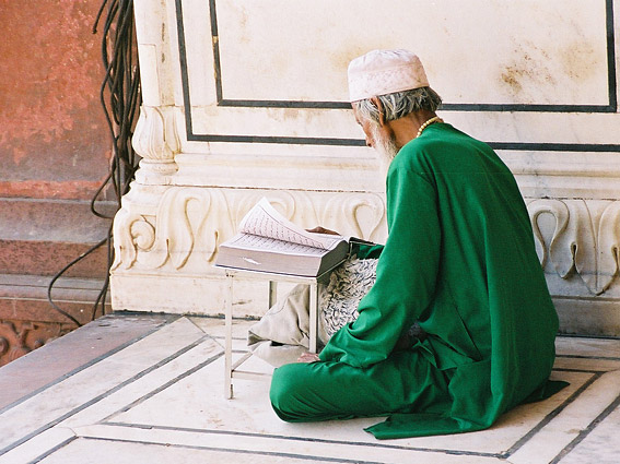 A Muslim man reads the Koran at the 17th-century Jama Masjid, one of India's largest mosques.