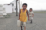 A young boy fetches water for his mother at a ger camp in Omnogov, South Gobi.