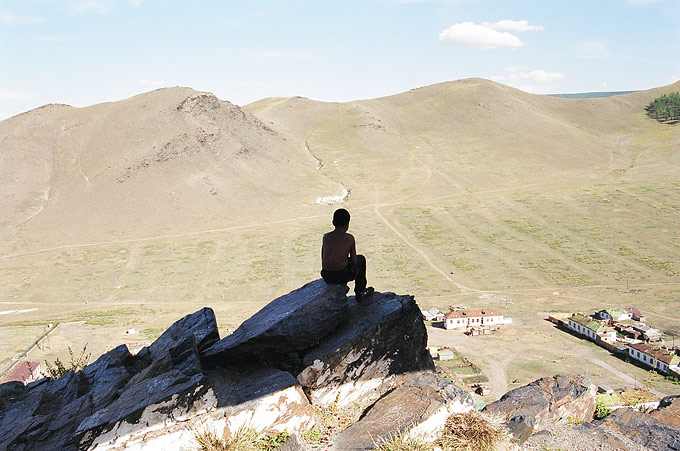 A young boy takes in the view from atop one of the picturesque mountains surrounding the capital.