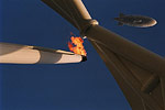 A security blimp flies over the Olympic Torch burning at the Olympic Stadium.