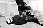 A tourist takes a nap on the steps of Palais Garnier, the city's grand opera house.