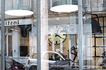 A building is reflected in a shop selling industrial furniture in the historic Marais quarter.