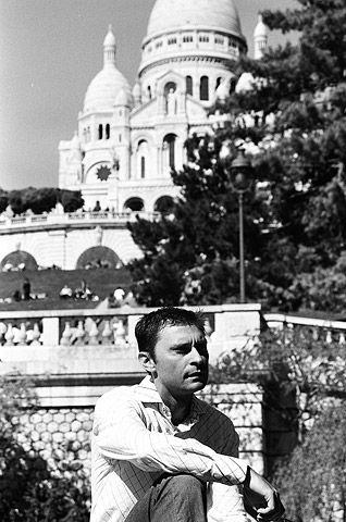 Achilles Tsaltas poses below the enormous white, wedding cake church known as the Sacre-Coeur basilica in the arty Montmartre area.