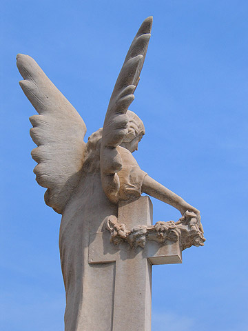 A statue above a tomb in one of the city's cemeteries.