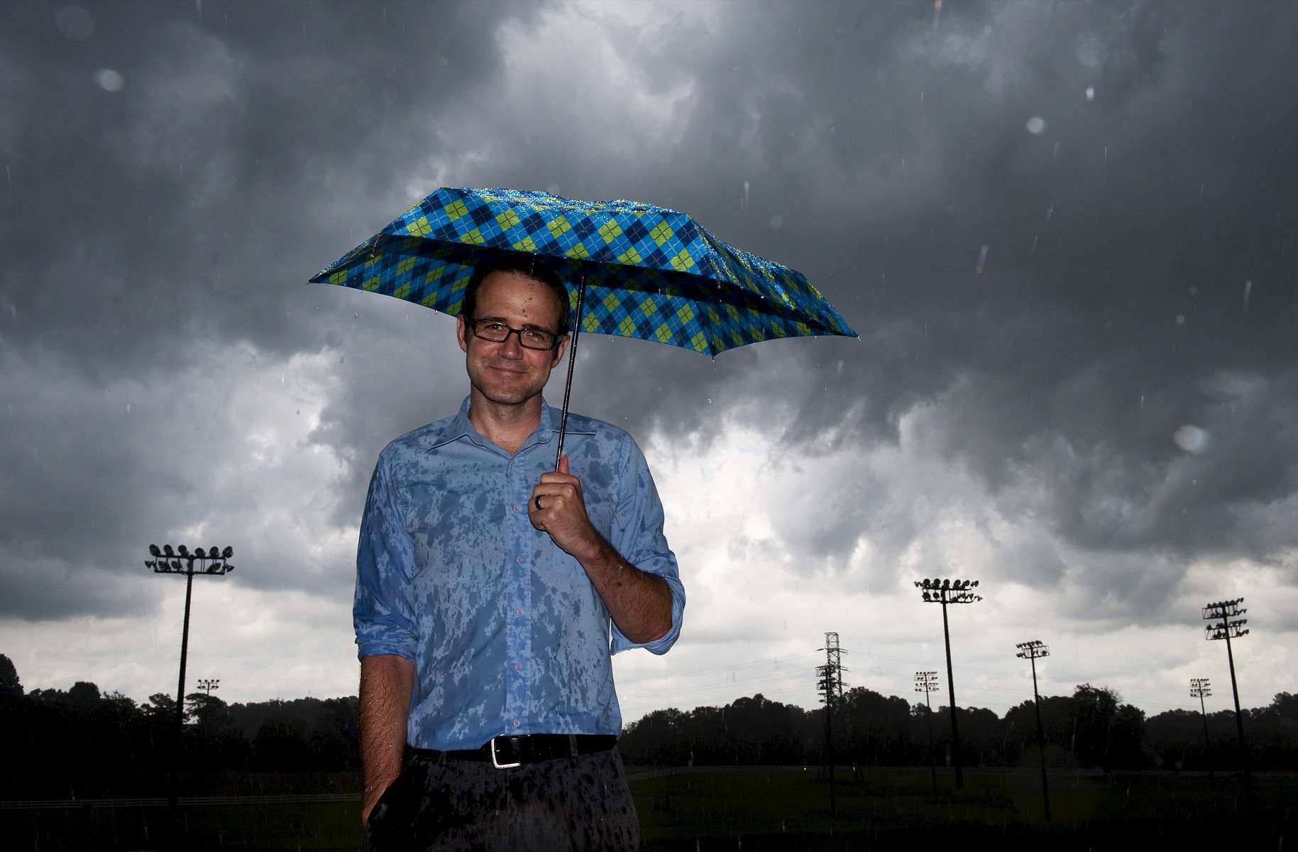 Graphic designer Christopher Eyl poses for a portrait as a summer storm rolls in.