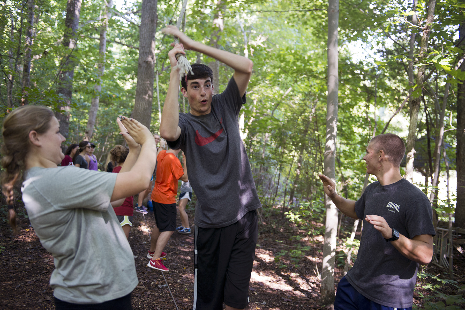 First year students work together to complete Elon University's low-ropes Challenge Course as a group-building exercise.