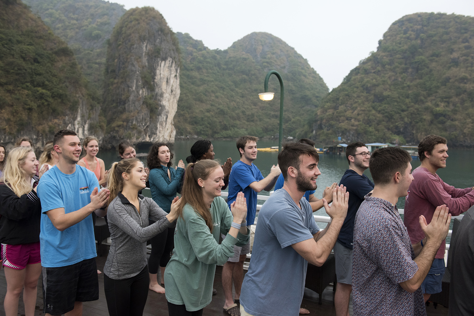 Elon students practice Tai Chi on the deck of a cruise boat on Halong Bay in central Vietnam while studying abroad.
