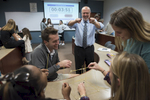 Business professor Rob Moorman laughs with his students as they compete to build the largest tower of tape, string, spaghetti and marshmallows.