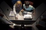 Anna Zwingelberg and Fletcher Rowe work together in a video editing suite in the redesigned School of Communications facilities.