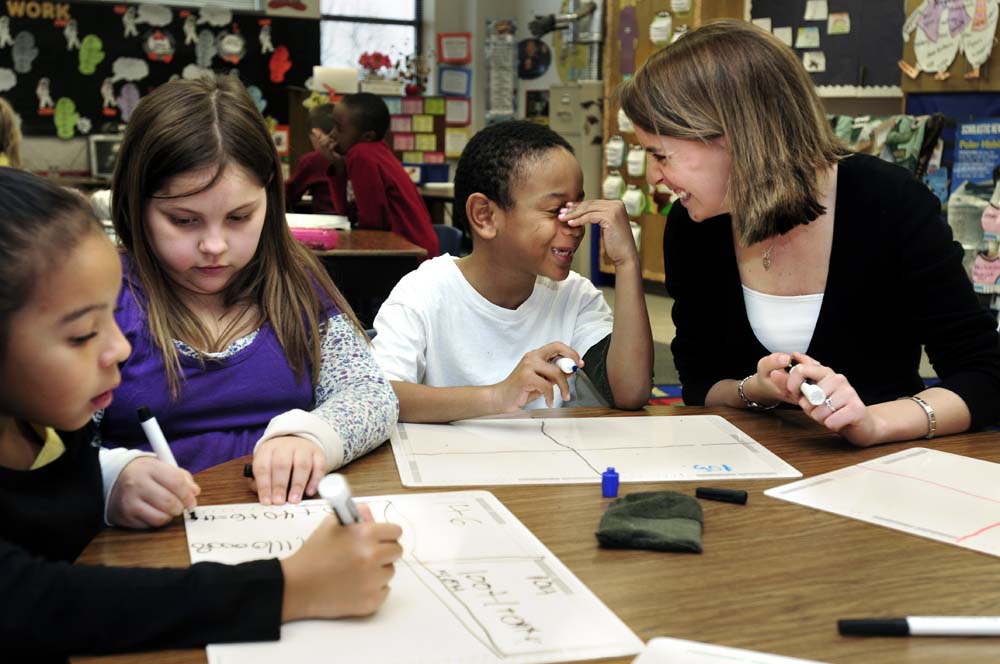 Student teacher Kara Cowdrick works on math with her second grade students at Audrey W. Garrett Elementary School in Mebane, N.C.