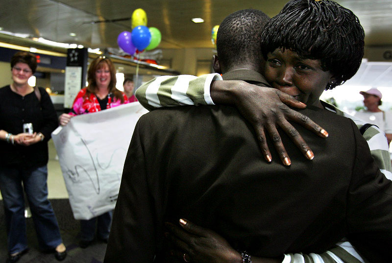 Sobbing as she sees Jimmy for the first time in five years, Alice clings to him after he arrived at the Greensboro, N.C., airport from Sudan. Alice's friends and supporters line up behind her, waiting for a turn to meet the man they struggled to get into the U.S. 
