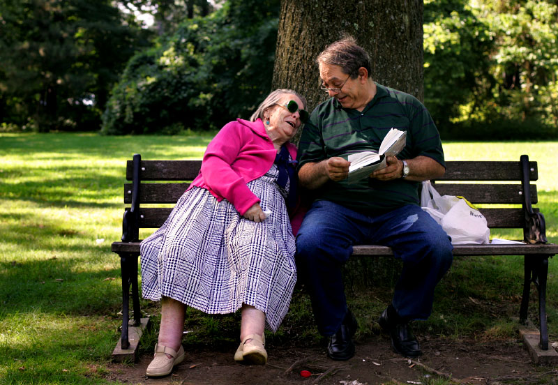 Michael Melts, 57, reads in Russian to his mother, Hannah Gilis, 85, in a shady spot at Hartford's Elizabeth Park. Gilis is legally blind, and Melts says he helps her out as often as he can. {quote}When I was a baby she cared for me and now I try to do the same. When she's happy, I'm happy too,{quote} he said.