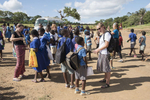 Each day after class, the Malawian children follow the Elon students to their bus, chatting and reaching to hold their hands. 
