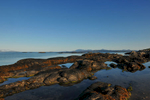 Low tide at Invercaimbe. Early morning light over rock pools, with the Cuilin Ridge on the Isle of Ske beyond.