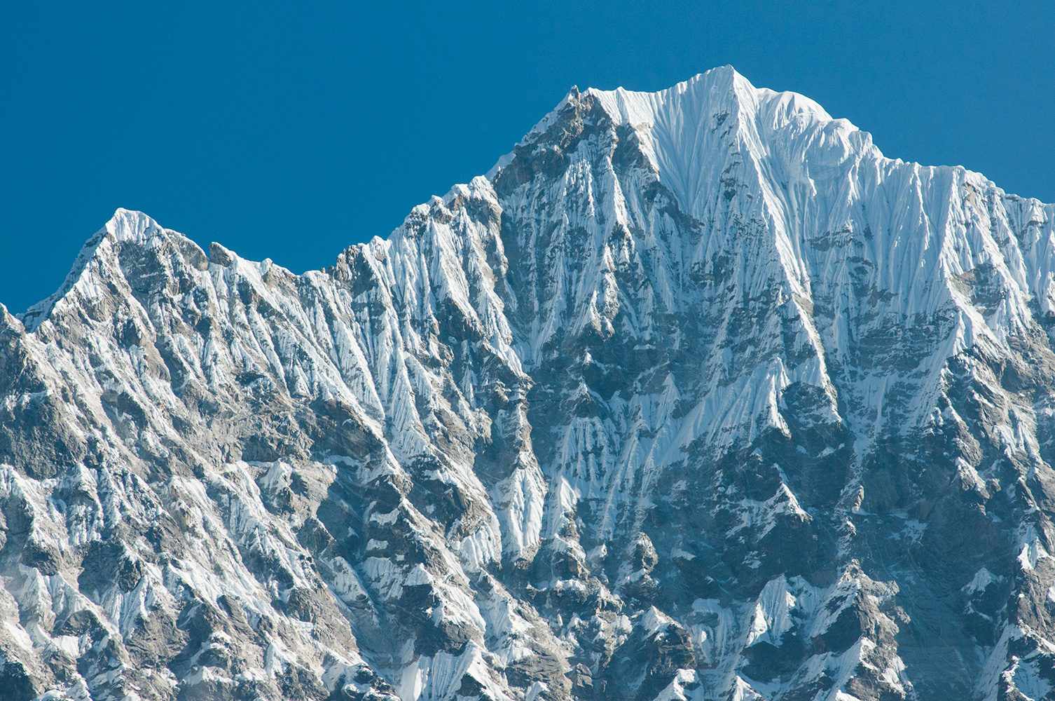 The first close-up view of a Himalayan giant on the walk in to Everest is of Thamserku, through the jungle from the trail near the village of Monjo.Nikon D300, 180mm. November 2008
