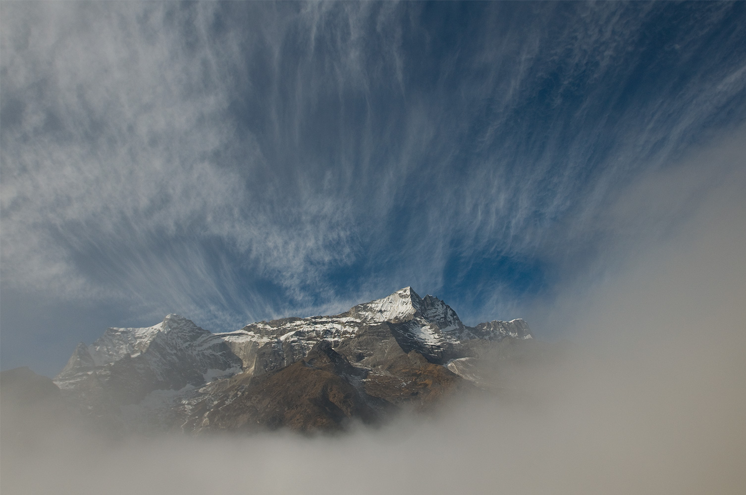 Mountains appearing through the morning mist at Khumjung vilage. December 2008