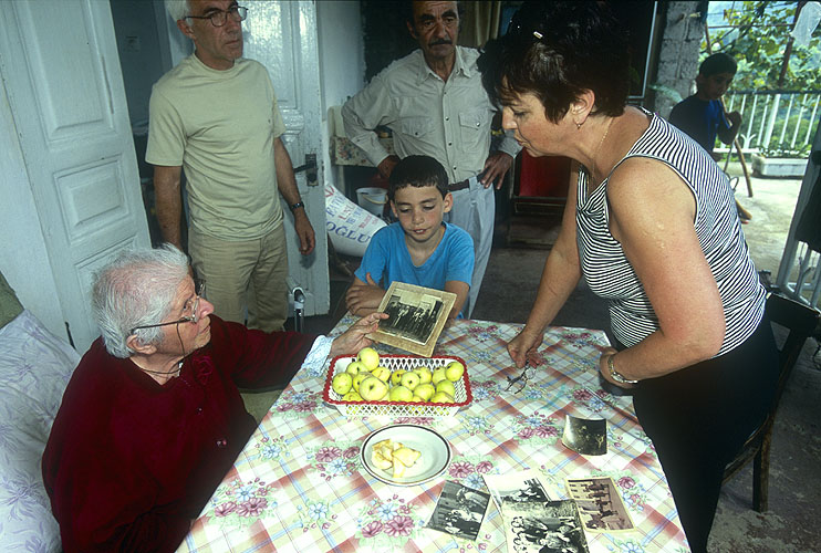 Valentina Krapchetova-Savvoulidi, president of the Batumi Pontic Greek Association, shares memories with Paresi Pavlidi and her family. They are one of the few remaining Greek families in this once thriving community.Nikon F5, 17-35mm, Fuji Velvia 100