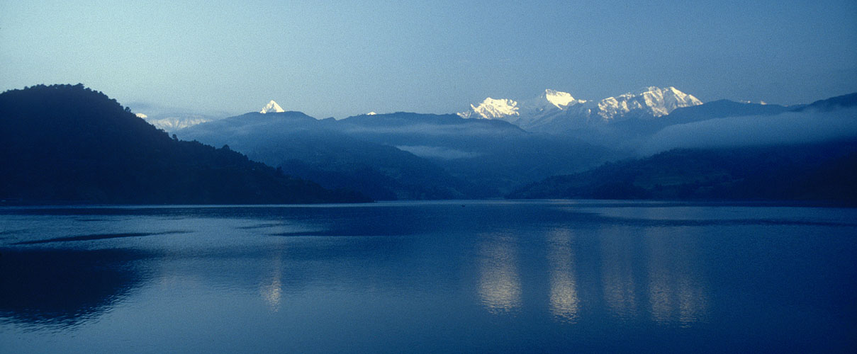 Annapurna IV (7525m), Annapurna II (7937m) and the Lamjung Himal reflected in the serene waters of Begnas Tal at sunrise.Nikon FM2, 24mm, Fuji Velvia