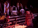 A woman lighting butter lamps in a Buddhist templeNikon FM2, 50mm, Fuji Velvia