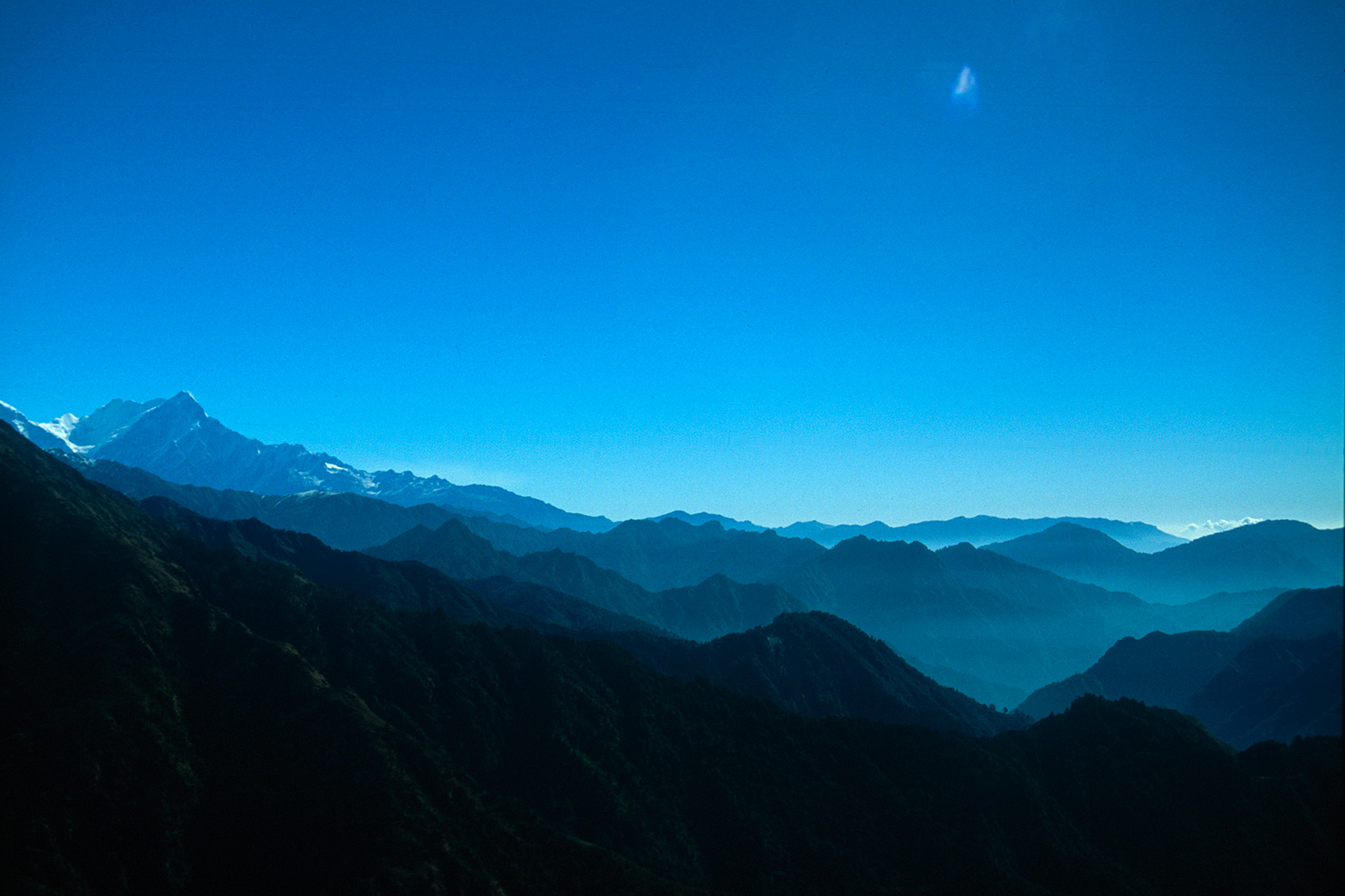 The Dhaulagiri Himal is a huge massif, and this pass lies at its western end, beneath the Gurja Himal. This is a view along the southern slopes, with the Annapurna Himal rising in the distance on the left.Nikon Fm2, 105mm, Fuji Velvia