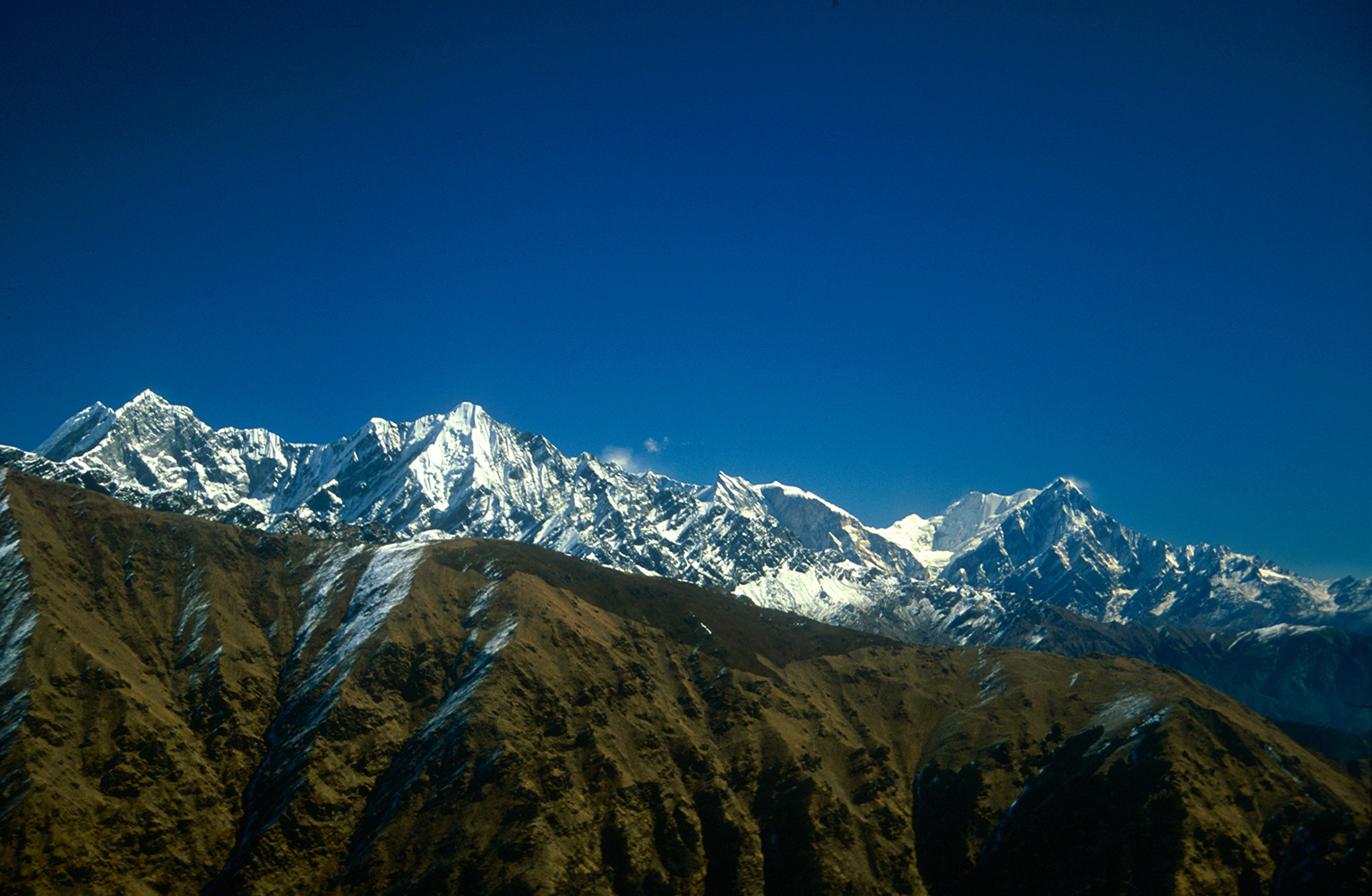 The west faces of (l to r) Manapati (6380m), Jirbang (6062m), Fang (7647m) Annapurna South (7219m) and Hiunchuli (6441m). Mountain vistas don't get any better!Nikon FM2, 105mm, Fuji Velvia