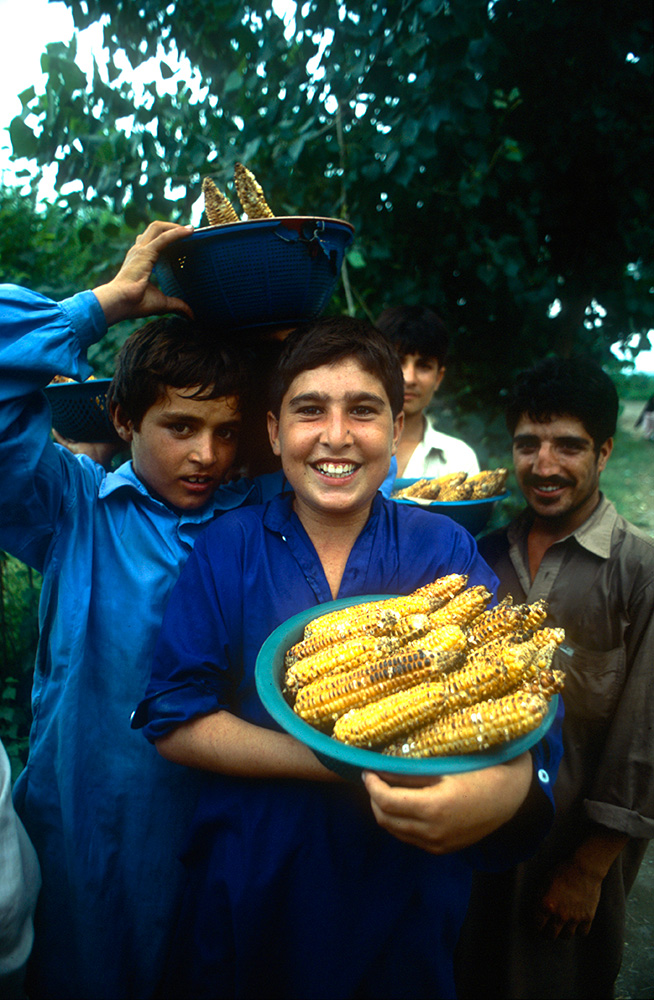 Everywhere vehicles stop on the Karakoram Highway, local people provide sustainance to travellers. These boys are selling roasted corn-on-the-cobNikon FM2, 24mm, Fuji Velvia