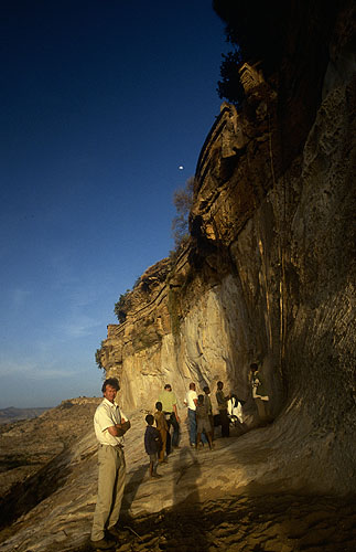 Beneath the cliffs from which we had just descended at the end of a long day's filming. The walkway into the monastery is visible atop the rocks above, and access is gained via ropes made of frayed, knotted hidesNikon F5, 17-35mm, Fuji Velvia 100