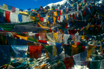 Tibetan prayer flags in the five auspicious colours swathe the rocks and cairns at the Dolma La (5630m), the highest point on the Kailas kora.Nikon FM2, 24mm, Fuji Velvia
