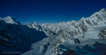 A panorama view down-valley from the summit of Gondogoro Peak (5650m), with Masherbrum on the far right, Trinity Peak on the far left, and the graceful spire of Layla Peak towering over the glacier. This is a stitch of two medium format colour slides (645) and the full resolution image is 6000 by 11000 pixels.