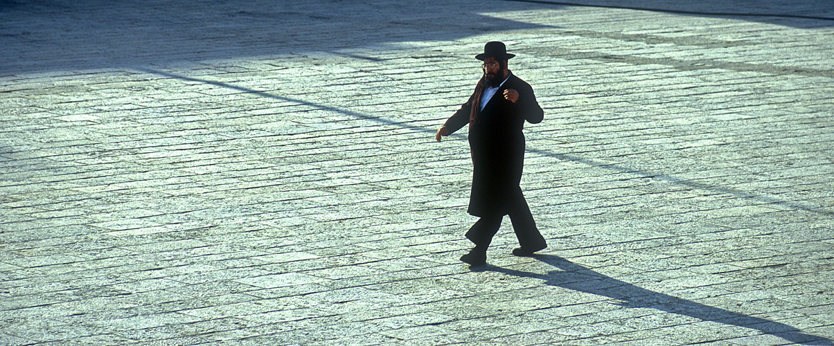 A Hassidic Jew crossing the large space that has been cleared in front of this focal point of Jewish religious activityNikon F5, 180mm, Fuji Velvia 100