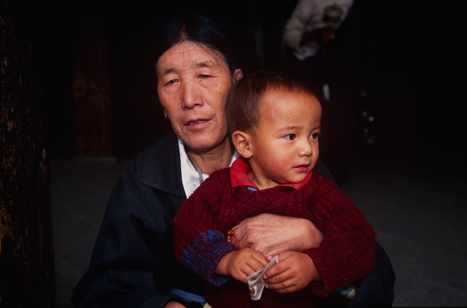 A woman pilgrim resting with her son in the courtyard.Nikon F5, 35mm, Fuji Velvia