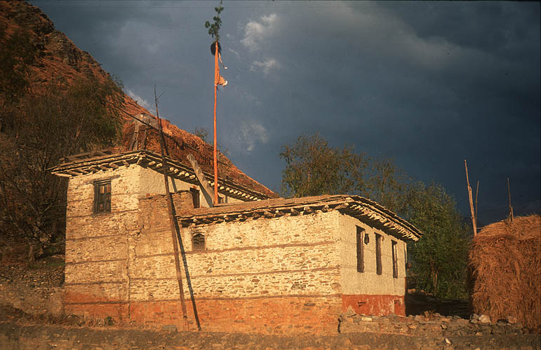 Against the stormy winter sky, a whitewashed farmouse in Jumla radiates the fading warmth of the sun.Canon EOS 500, 28mm, Fuji Velvia