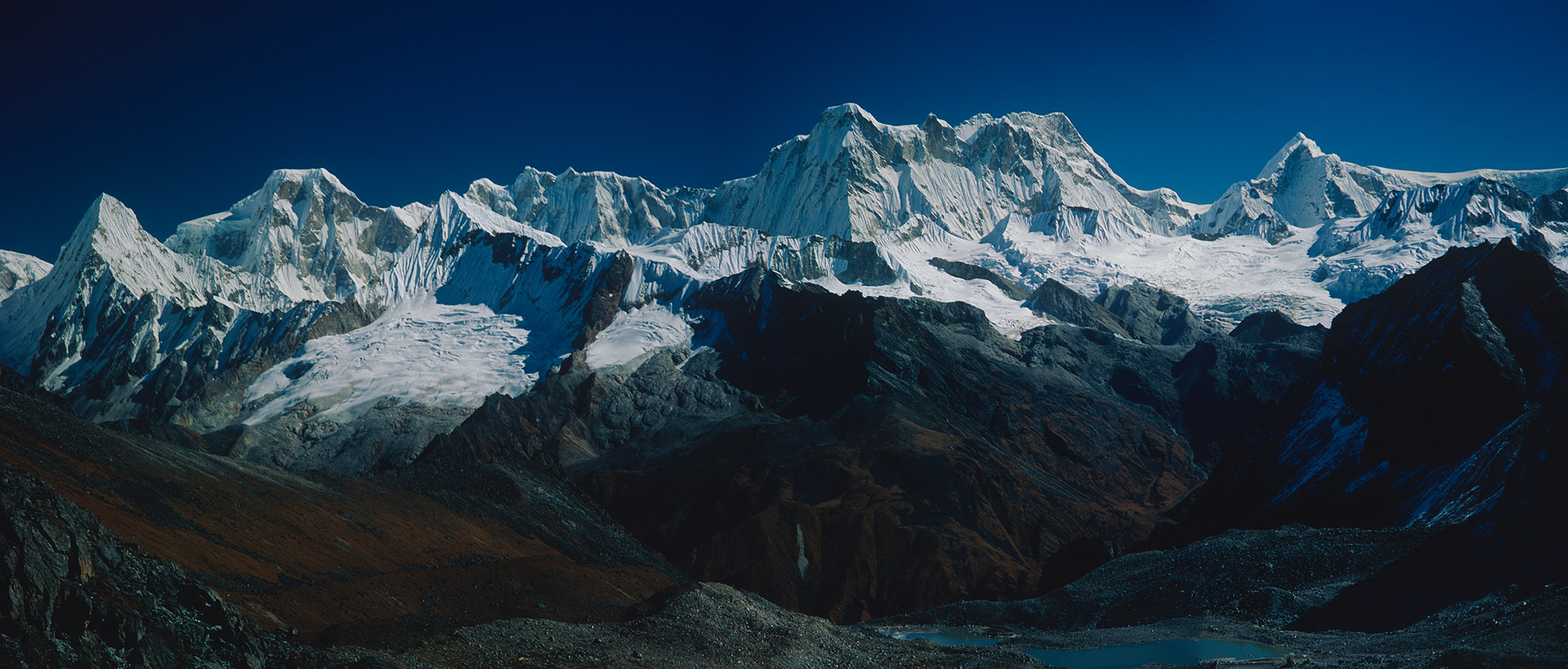 A panorama of three telephotos, taken from the crest of the Kanglakarchung La on the Snowman Trek. Stitched together in Photoshop to make a 14,000 pixel wide image. The central peak is Teri Kang, 7127m.Bronica ETRSi, 150mm, Fuji Velvia