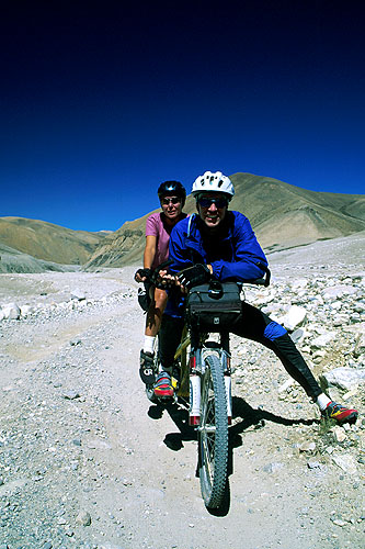 Ken & Cindy Dowling taking a breather on the final approach to Rongbuk and the north-face base camp of Everest. They were the first people ever to ride a tandem to Everest.Nikon FM2, 24mm, Fuji Velvia