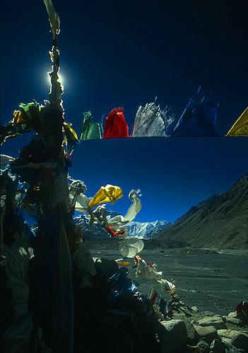 Prayer flags silhouetted against the afternoon sun at  Everest base camp on the Rongbuk glacierNikon F5, 17-35mm, Fuji Velvia 100