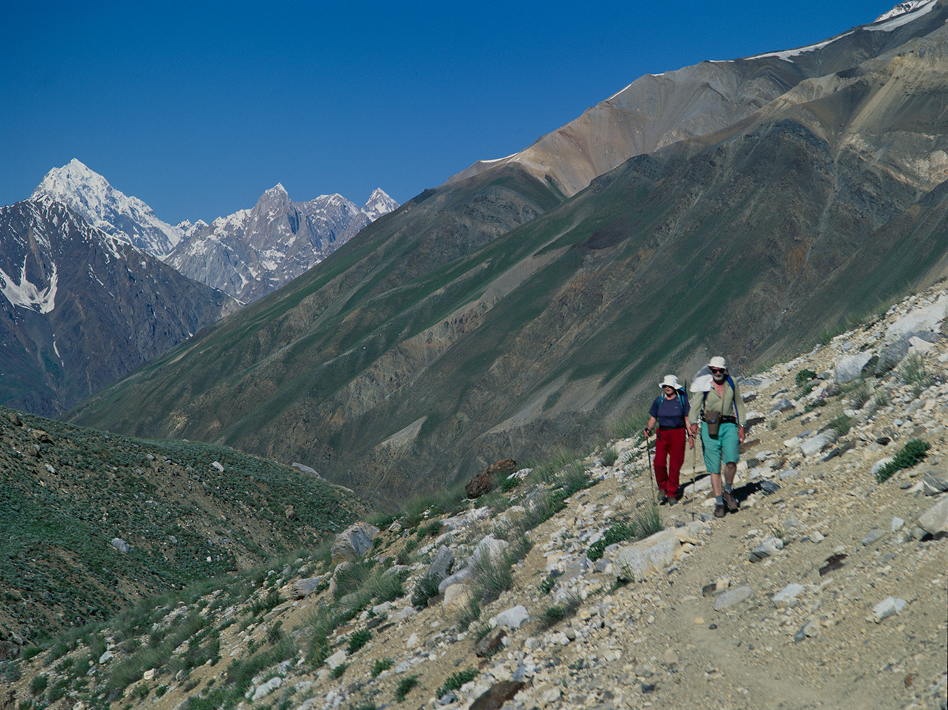 Trekkers approaching this 4259m pass from the upper Turikho valley / Shah Jinali Gol. The pass links the Turikho valley with the village of Lasht in the Yarkhun.Bronica ETRSi, Fuji Velvia