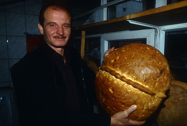 The village baker proudly displays his produceNikon F5, 17-35mm, Fuji Velvia 100