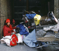 1999 - Homeless couple living on the streets of New York City with shopping carts.