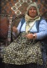 A Turkish woman works some wool at a carpet market in the Cappodochia region of Turkey.