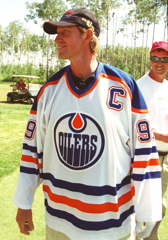Wayne Gretzky smiles after teeing off in an old style Edmonton Oilers jersey during the Ronald McDonald Children's Charities Wayne Gretzky and Friends Golf Tournament at the Northern Bear Golf Club just southeast of Edmonton. It was the first time since being traded by the Oilers in August of 1988 that he has put on the jersey. Gretzky saw a fan in the crowd wearing the jersey and asked him to take it off for a signiature. Gretzky signed the jersey then proceeded to put the jersey on himself and teed off on the 12th hole with it then gave it back to the happy fan.  Edmonton Sun Photo by Aaron Whitfield