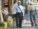 Two men pass on the street while out running errands in Gujo-Hachiman, Japan.