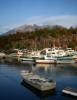 Fishing boats lie in wait beneath the worlds most active volcano, Sakurajima, near Kagoshima, Kyushu.