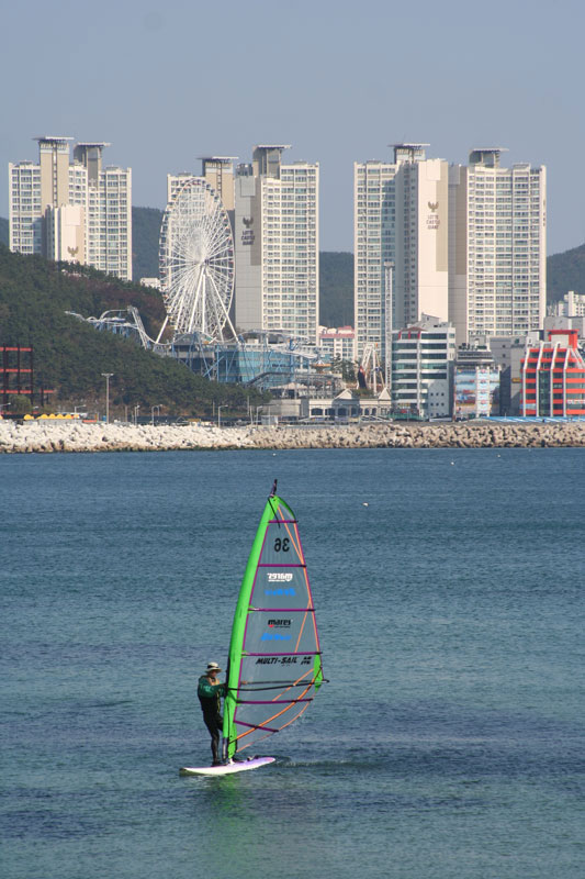 A windsurfer takes a break from the hectic pace of the big city at Gwangalli beach in Busan, South Korea.