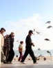 Sea Gulls scatter as people walk on a walkway above Haeundae Beach, in Busan, South Korea.