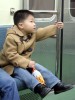 A boy is dressed to impress as he rides the train in Busan, South Korea.