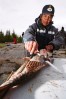 Elder, Jonas, filets a Northern Pike during shore lunch at Trout Rock Lodge, NWT, Canada. Jonas grew up on the land where the lodge is located and has worked there since it opened.