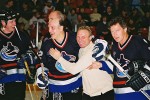 Tiger Williams gives a helping hand to teammate Edie Mio after the Vancouver Canucks Alumni Team won the Three-on-Three Charity HockeyTournament in Calgary.