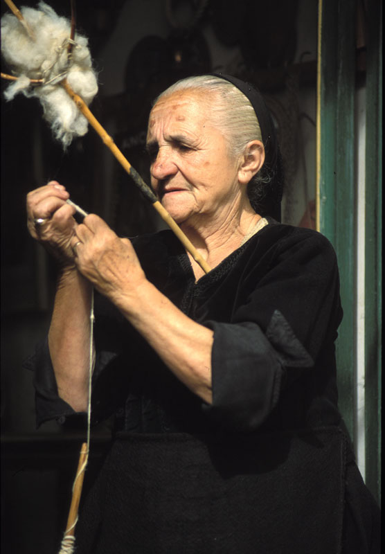 A widow weaves some wool at her shop in a small town in northern Greece.
